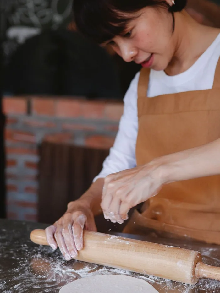 Priya Raman shaping dough at Prairie Loaf
